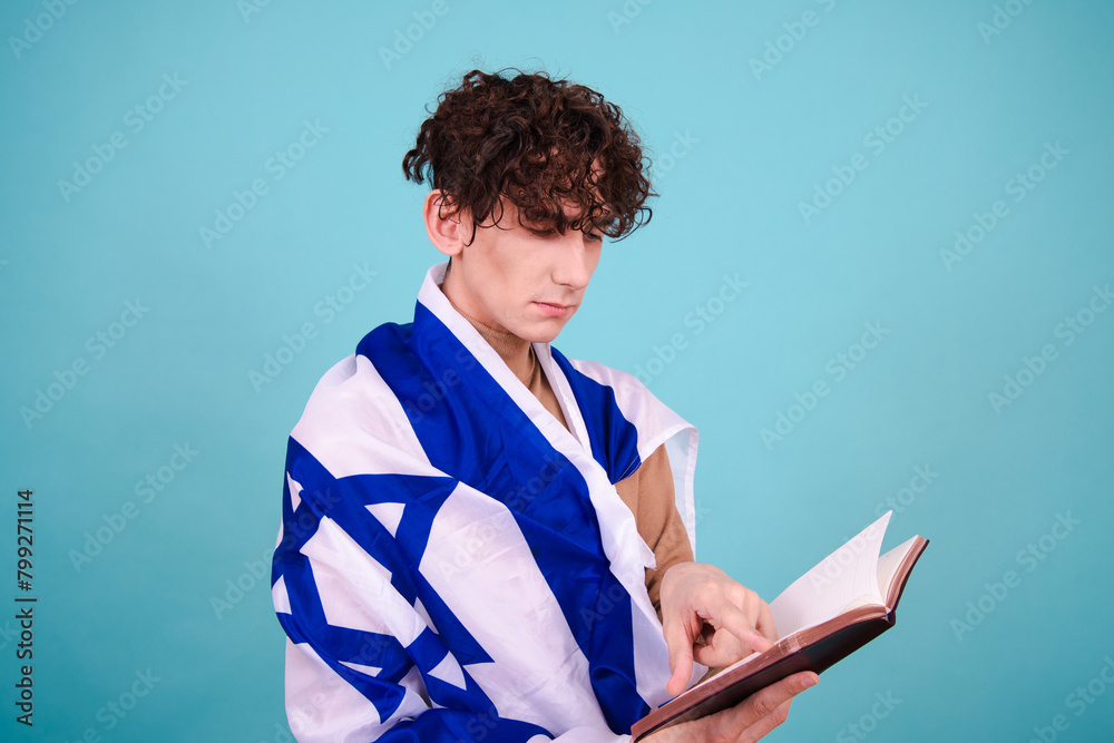 A young attractive guy is studying. A man with an Israeli flag. A young attractive guy is studying. A man with an Israeli flag.