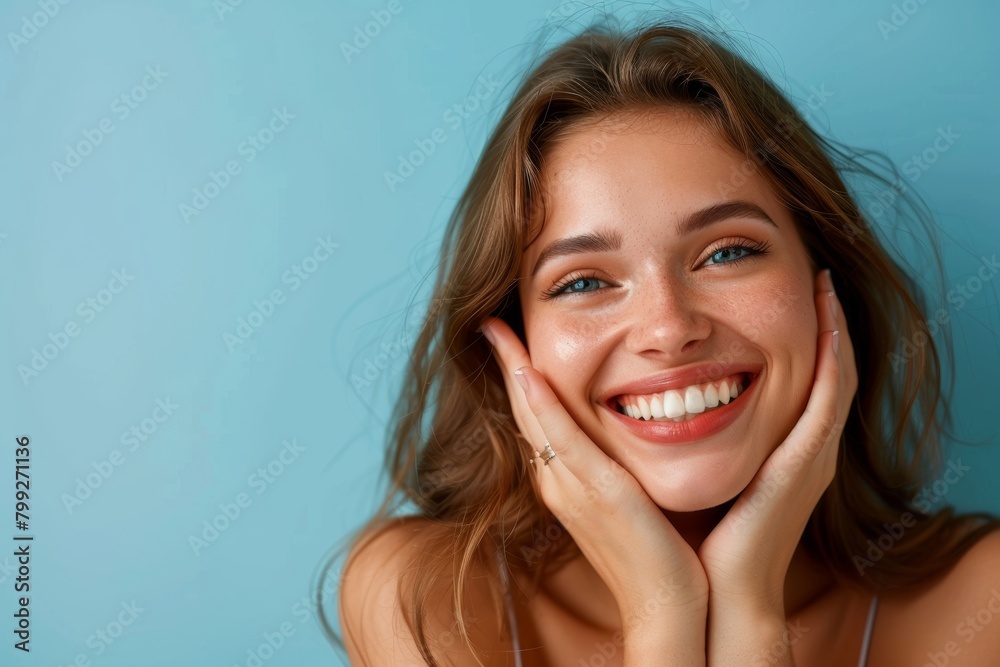Studio portrait of beauty, woman, and smile for skincare, dermatology, and wellness cosmetics on blue backdrop. Happy mature female model, facial, and laser transformation aesthetic enthusiasm Studio portrait of beauty, woman, and smile for skincare, dermatology, and wellness cosmetics on blue backdrop. Happy mature female model, facial, and laser transformation aesthetic enthusiasm