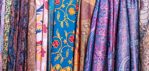 Traditional silk Uzbek scarves with colorful pattern at the oriental bazaar in Tashkent in Uzbekistan close-up