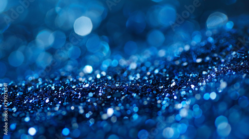 Sapphire-blue glitter dances with elegance amidst a blurred setting, conjuring visions of deep ocean waters and boundless serenity.