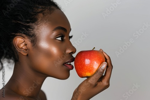 Studio background with woman, apple with face profile, nutrition, fruit, and good diet. Wellness, lifestyle, weight loss, organic and fresh produce for joyful female eating