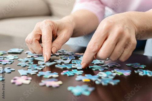 Cropped of Woman Placing Puzzle Piece on Table