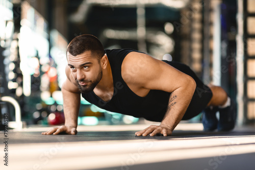 Man Doing Push Ups in Modern Gym