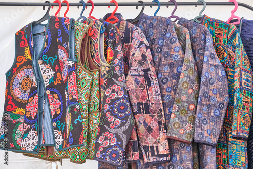 Women's quilted vests and robes with traditional colorful patterns. Crafts fair, Almaty, Kazakhstan