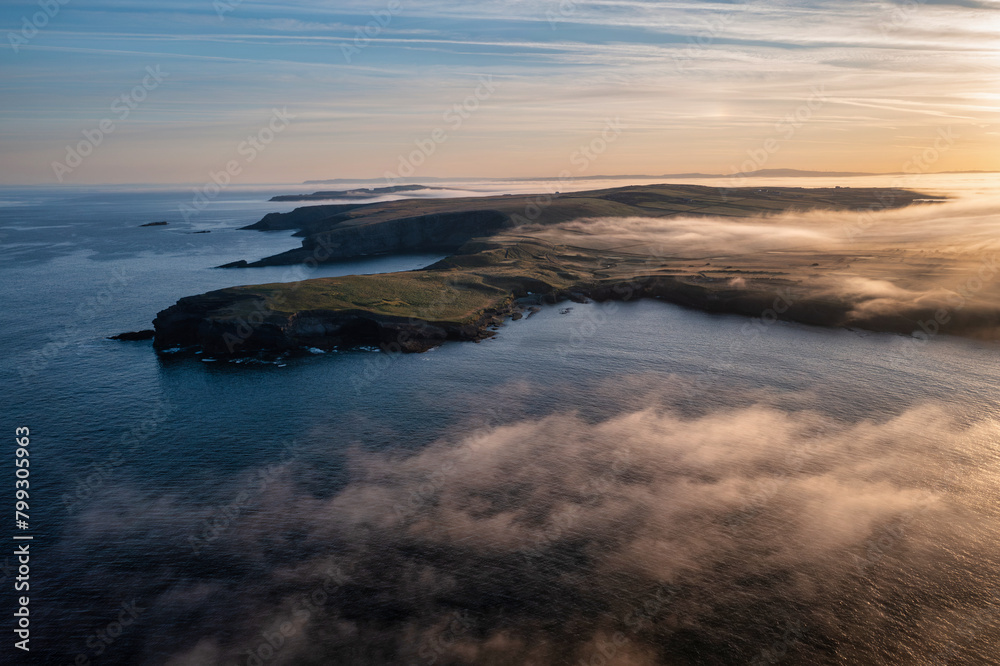 Misty sunrise over the rocky coast of Kilkee, Co. Clare. Ireland