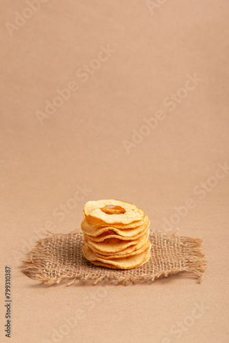 Healthy snack. Apple chips on a beige background.