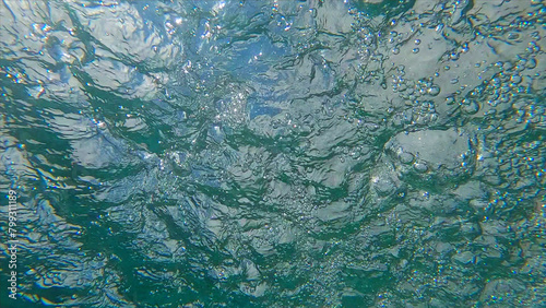 Underwater view on the churning water surface photo