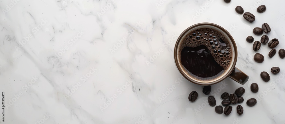 Fototapeta premium Hot black coffee is served in cups and placed on a white marble table