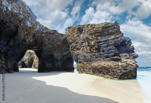 Natural rock arches on Cathedrals beach in low tide (Cantabric coast, Lugo, Galicia, Spain). photo