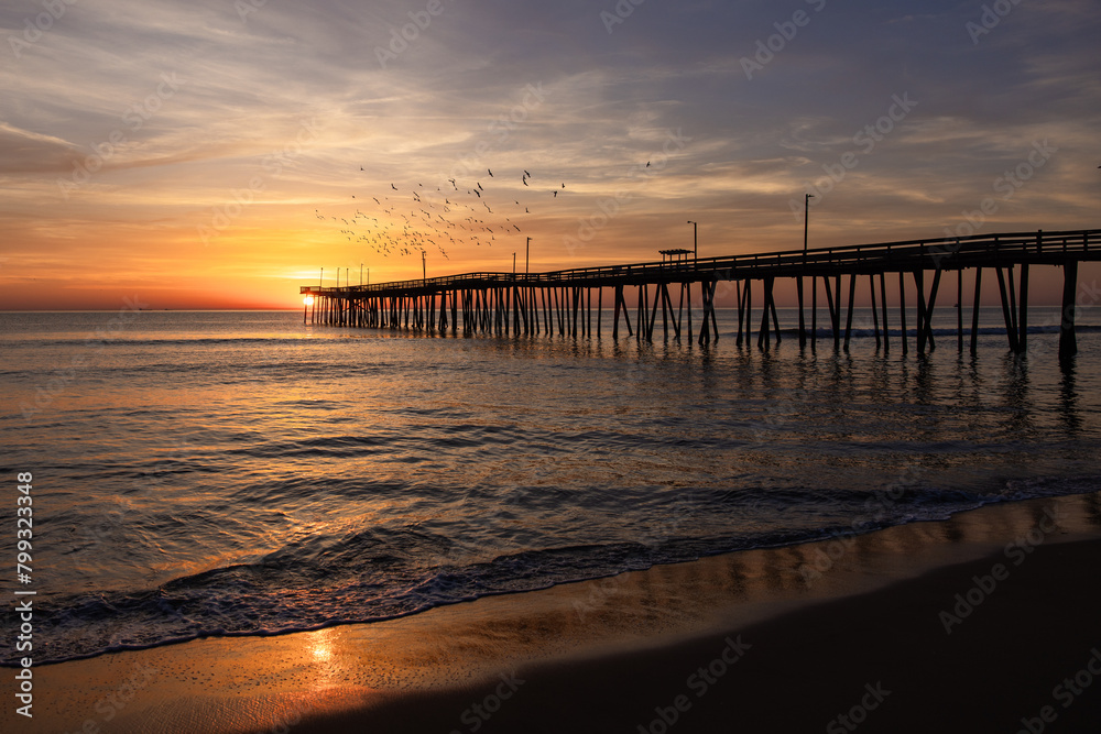 sunrise at the pier With birds flying over