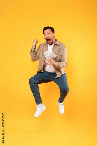 Man Jumping in the Air With a Bunch of Money