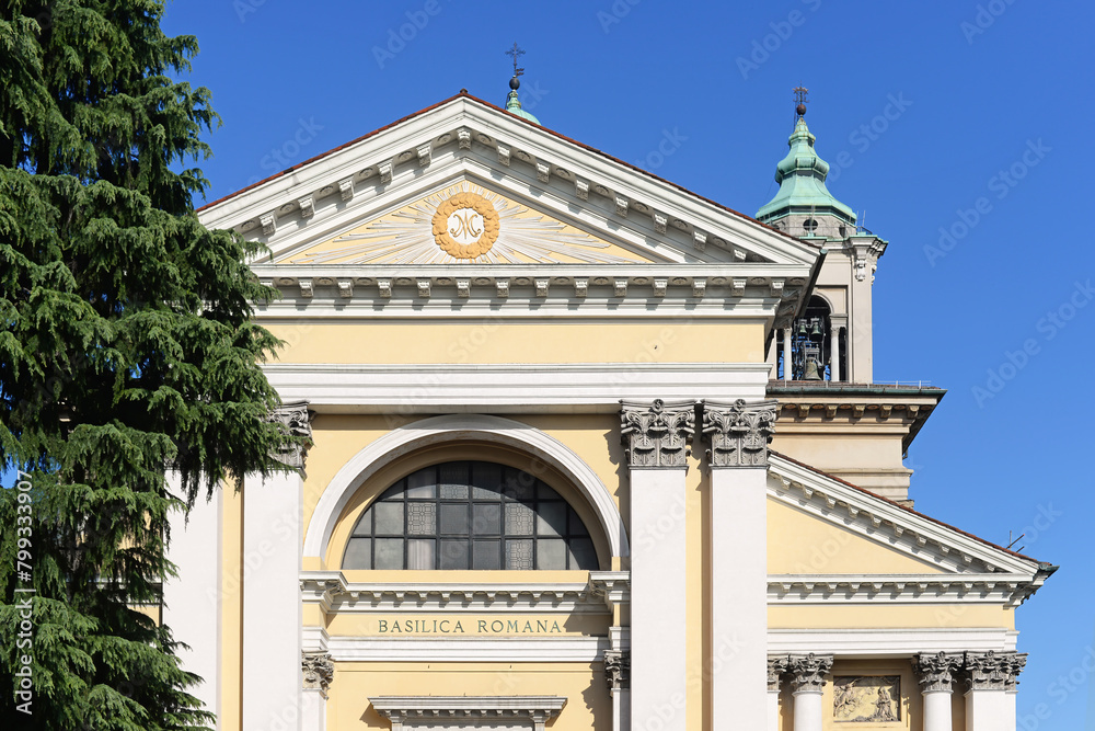 Part of the gable of the Sanctuary (Santuario della beate vergine) with tympanum and bell tower in Rho, near Milan, Italy, with clear blue sky Part of the gable of the Sanctuary (Santuario della beate vergine) with tympanum and bell tower in Rho, near Milan, Italy, with clear blue sky