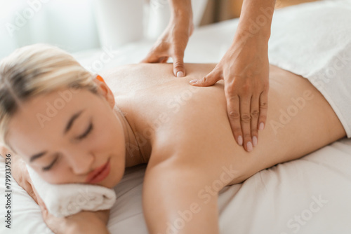 Woman Receiving Back Massage at Cozy Spa