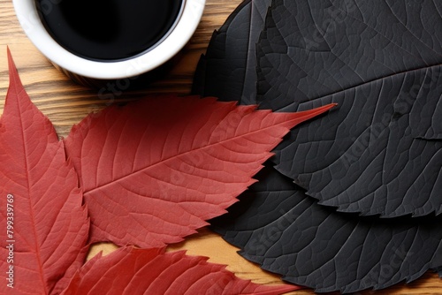 Autumn leaves and coffee cup on a wooden background