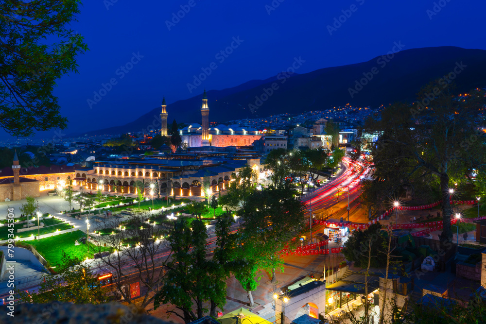 Fototapeta premium Bursa Ulu mosque and its surroundings at night with long exposure from Tophane park or Torphane square, Bursa, Turkey