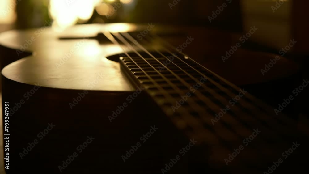 cinematic, classical guitar in the rays of the setting sun, sunset color 4k slow motion. music lifestyle