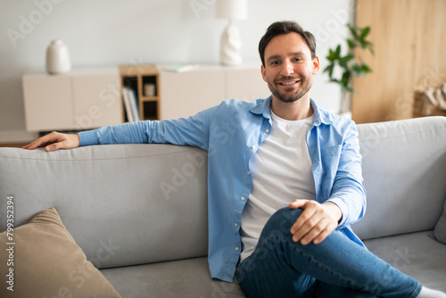 Man Sitting on Couch in a Living Room