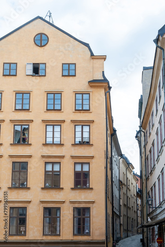 Sweden Stockholm  imposing building with big window narrow paved alley Gamla Stan Old Town. Vertical