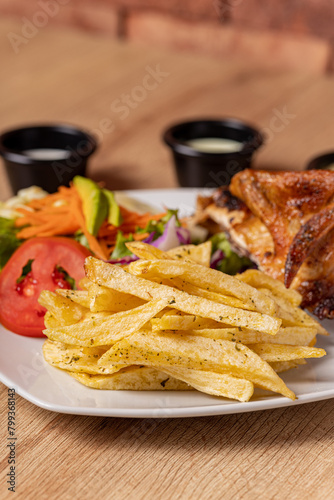 Peruvian grilled chicken, with fries and salad.