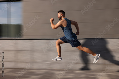 Sporty young man running on street. Motion blur effect showing his speed © New Africa