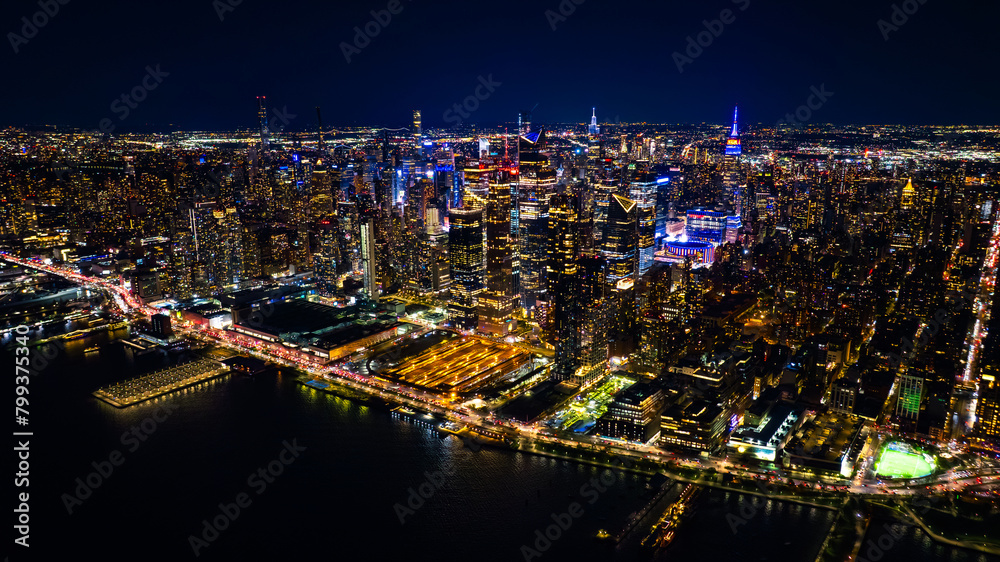 Naklejka premium Night scenery of New York, the USA with fantastic illumination. Skyscrapers in the scenery of metropolis are dazzling and sparkling with lights. Top view.