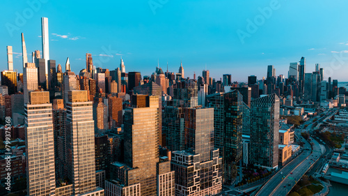 Skyline of New York at the waterfront of the East River in New York  the USA. Drone approaching the scenery of metropolis at sunset.