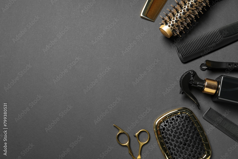 Fototapeta premium Hairdressing tools on dark table, flat lay. Space for text