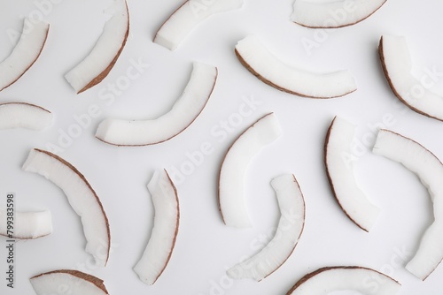 Pieces of fresh coconut on white background, top view