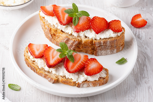 Homemade Crispbread toast with Cottage Cheese and Strawberry on white wooden board