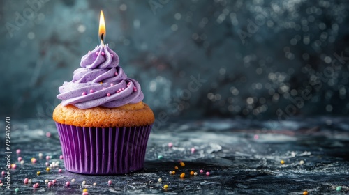 Cupcake With Lit Candle Surrounded by Sprinkles