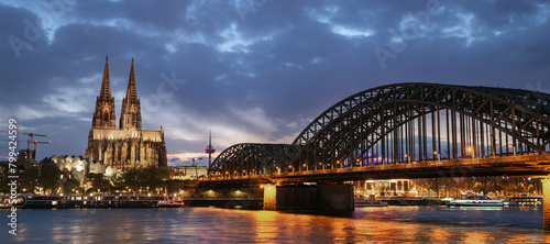 Panoramic view of the Cologne Cathedral and Hohenzollern Bridge at night, travel background photo