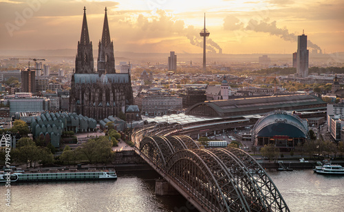 Ariel view of Cologne Cathedral, Rhine river, Cologne central station and Hohenzollern Bridge at sunse photo