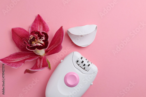 modern epilator for removing unwanted body hair on a bright background. Home hair removal method photo