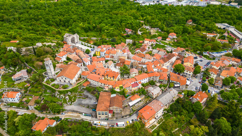 Kastav, a charming town perched on a hill overlooking the Adriatic Sea near Opatija, Croatia, offers a picturesque setting steeped in history and natural beauty captured by drone