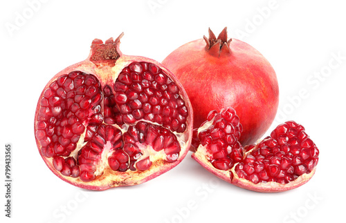 Cut and whole pomegranates isolated on white