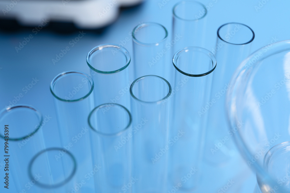 Laboratory analysis. Glass test tubes on white table indoors, closeup Laboratory analysis. Glass test tubes on white table indoors, closeup