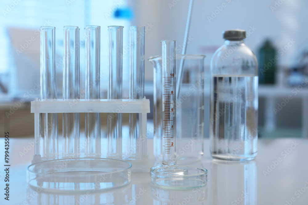 Laboratory analysis. Different glassware on white table indoors Laboratory analysis. Different glassware on white table indoors