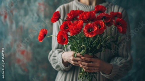 close-up of a woman holding a bouquet of red poppies. selective focus