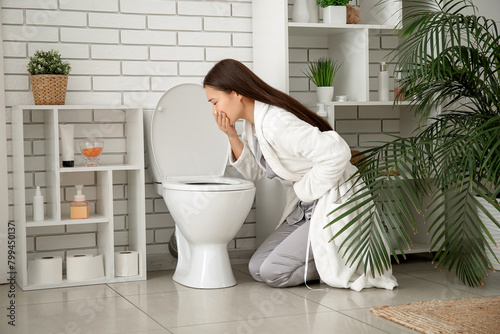Sick young Asian woman near...