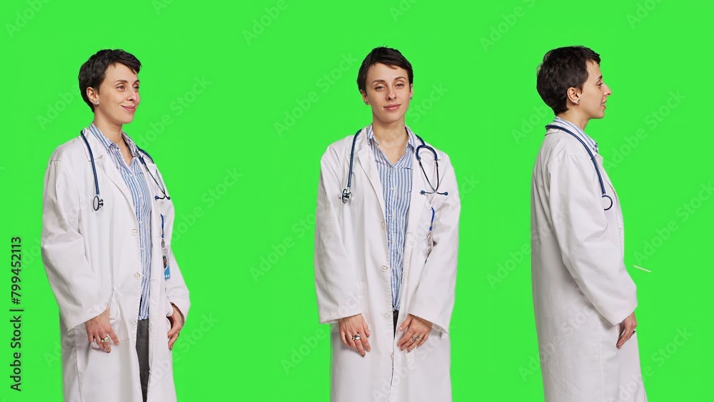 Portrait of physician wearing a white coat and a stethoscope for exams, standing against greenscreen backdrop. Doctor specialist working in healthcare industry, medical expertise. Camera B. Portrait of physician wearing a white coat and a stethoscope for exams, standing against greenscreen backdrop. Doctor specialist working in healthcare industry, medical expertise. Camera B.