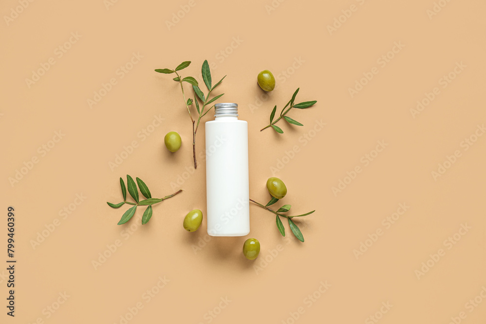 Obraz premium Bottle of cosmetic product with olives on brown background