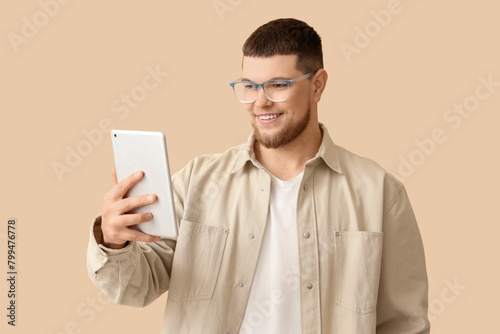 Young man in eyeglasses usi...