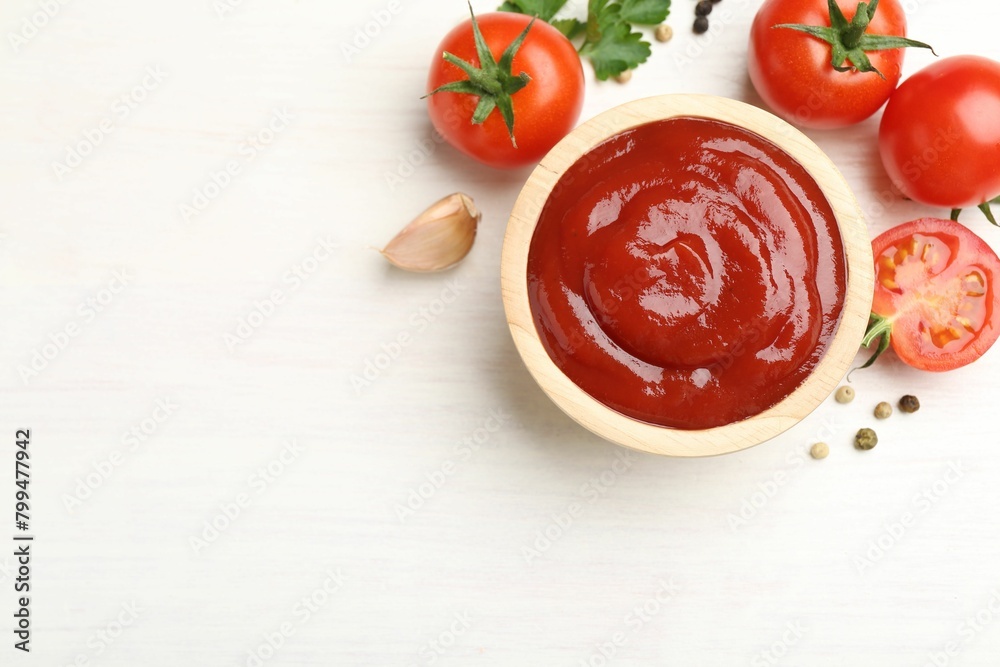 Delicious ketchup in bowl, peppercorns and tomatoes on white wooden table, flat lay. Space for text Delicious ketchup in bowl, peppercorns and tomatoes on white wooden table, flat lay. Space for text
