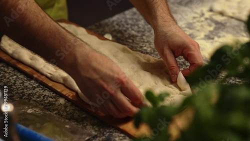 cloeup shot of chef's hands kneading pizza dough, pizza making concept. High quality 4k footage photo
