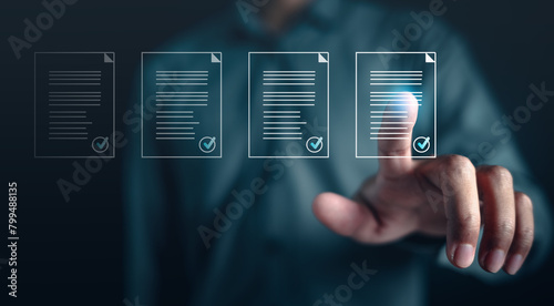 information, checklist, list, check, paper, contract, document, law, legal, paperwork. A man is pointing at a screen with documents. The documents are all different sizes and are all on the same page.