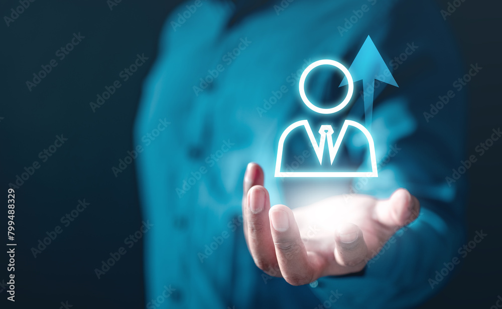 community, employment, find, future, group, human, leader, leadership, hr, management. A man is holding a hand up to a picture of a man in a suit.