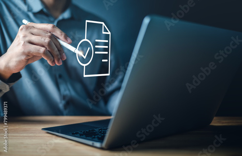 file, document, email, report, information, network, graphic, data, communication, form. A man is using a laptop with a check mark on a document. Concept of approval or validation.