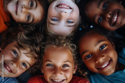 Group of diverse children smiling and looking at camera. Top view.