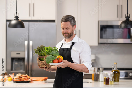 Man cook cooking healthy food in chef apron at home kitchen