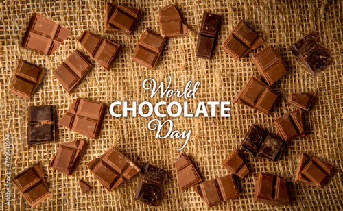 Chocolate piece background on a rustic jute background with international chocolate day text